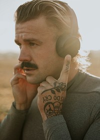 Cool urban man listening to music while working out