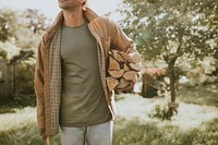 Man standing with axe and chopped lumber and stump on a farm