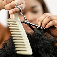 Hairstylist trimming the customer's hair at a beauty salon