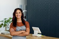 Smiling female small business owner at a cash register