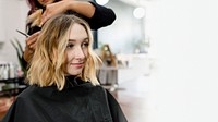 Woman getting her hair curled at a beauty salon 