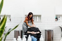 Hair stylist rinsing hair of the customer