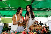 Lesbian couple grocery shopping at a local market