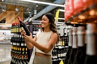 Woman buying wine, supermarket shopping HD image