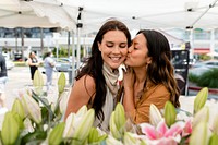 Lesbian couple flower shopping at a local market