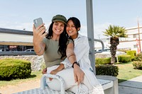 Lesbian couple taking selfies on a date
