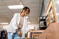 Woman picking picture frame at a home decor shop