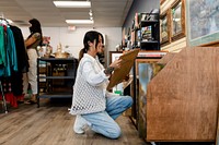 Woman picking picture frame at a home decor shop