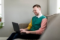 Smiling man using laptop, HD stock image