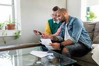 Gay couple paying bills, HD stock image