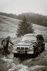 Off-roading road trip car stuck in the water