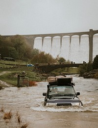 Car stuck in a flood near the dam structure