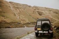 Car driving by the river on a off-roading trail