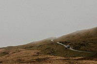 Car driving through a rugged terrain landscape 