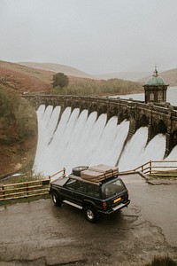 Car parked to a hydroelectric power generating dam 