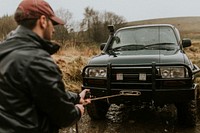 Man pulling the car towing cable