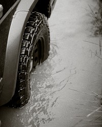 Car tire closeup stuck in the water