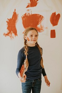 Playful child painting walls for home remodelling