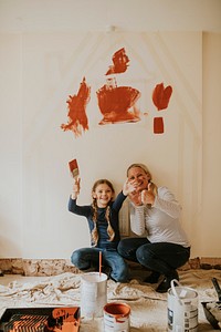 Playful kid and mother home painting