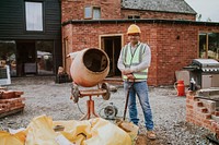 Contractor next to a cement mixer