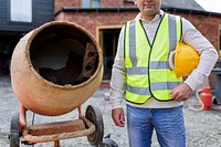 Contractor next to a cement mixer