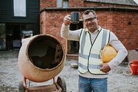 Contractor take a break next to a cement mixer