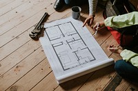 Contractors reading floor plan at a construction site