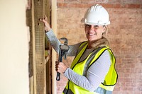 Woman worker remodeling home with a wrench