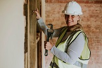 Woman worker remodeling home with a wrench