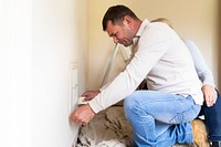 Husband fixing broken home ventilation