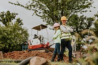 Playful father and daughter at a construction site