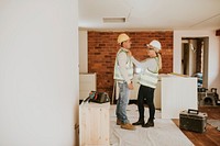 Playful couple remodeling home together