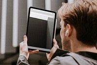Digital tablet mockup psd being used by a man 