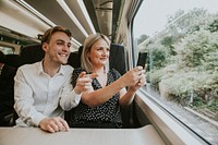 Couple by the train window taking photo of the scenery