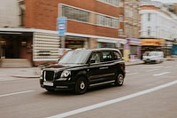 Vintage car travelling through London street