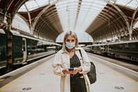 Woman using a phone at a train station 