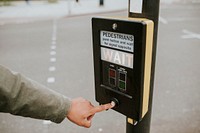 Person pressing a pedestrian cross push button 