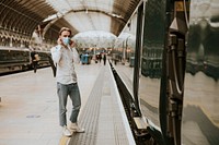 Man waiting for a train on a platform 