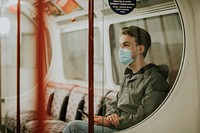 Man sitting on train and using a smartphone in the new normal 