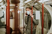 Man calling someone on a phone on a train in the new normal 