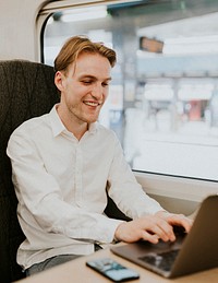 Man working on a laptop on his business trip on a train