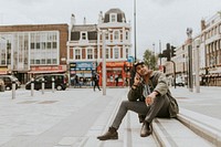 Man sitting on a step talking on a phone 