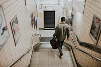 Man descending from the stairs towards the underground station 