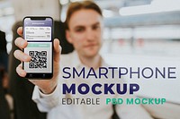 Smartphone mockup psd with application for booked ticket being shown by a man