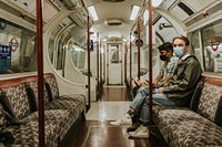 Friends using a smartphone on a train in the new normal