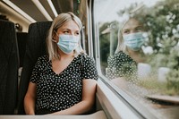 Woman sitting by a train window in the new normal 