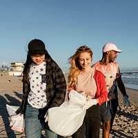 Trash pick up volunteering, group of teenagers at the beach