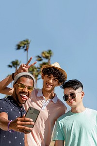 Teen boys taking selfie, playful summer in Venice Beach, Los Angeles