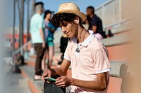 Teen boy listen to music, at a skatepark in Venice Beach, Los Angeles