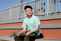 Teen boy with skateboard, summer hobby sport activity